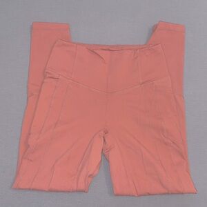 Pink athletic leggings with pockets.